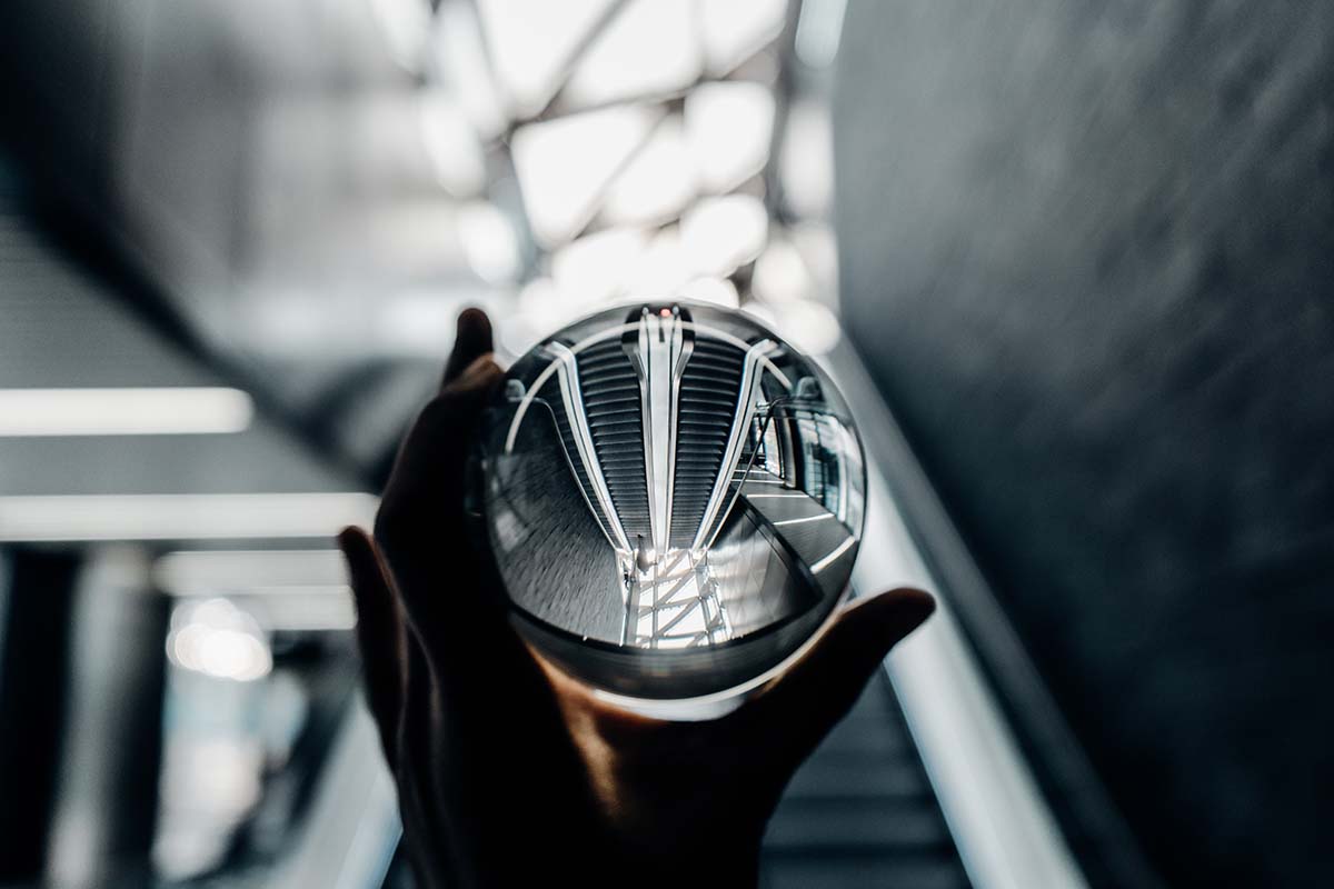 Crystal ball reflection of modern architecture and escalator